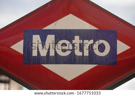 A somewhat dirty and neglected Madrid Metro signal, located above the underground access to the Antón Martín metro station and stop in the center of Madrid.