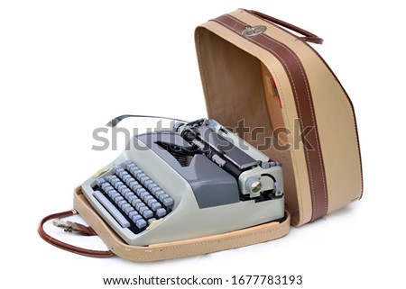Old typewriter with leather brown suitcase on white background.