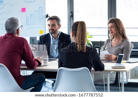Shot of business people discussing together in conference room during meeting at office.