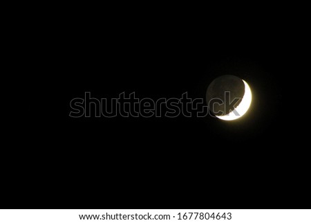 crescent moon on the black sky