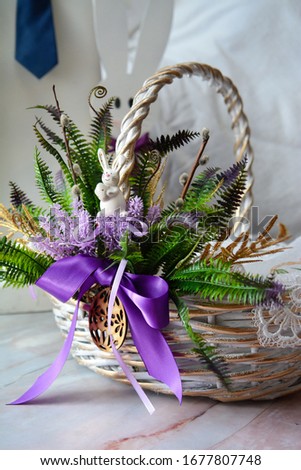 Beautiful easter basket with a rabbit. White basket with violet bow. Easter. Easter decoration