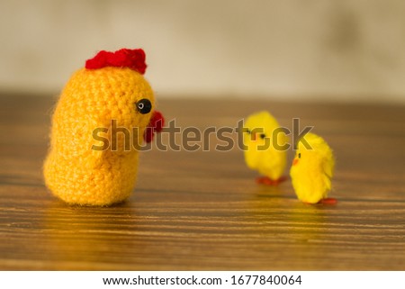 Easter photo of two chicks and a hand-crocheted chicken