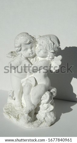                                figurine of two hugging gypsum angels
