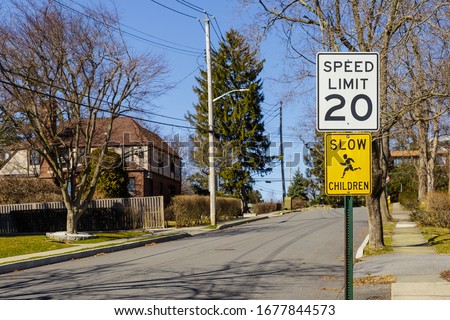Road sign displaying 20 mph speed limit near the school or kindergarten in the american neighbourhood