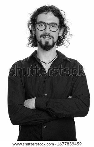 Portrait of happy handsome bearded businessman with eyeglasses smiling
