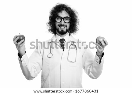 Happy man doctor smiling while holding red apple and green apple