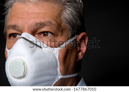 close up, face of a man wearing a PPE, FPP2 mask Royalty-Free Stock Photo #1677867010