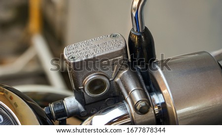 Close up of motorcycle brake fluid Royalty-Free Stock Photo #1677878344