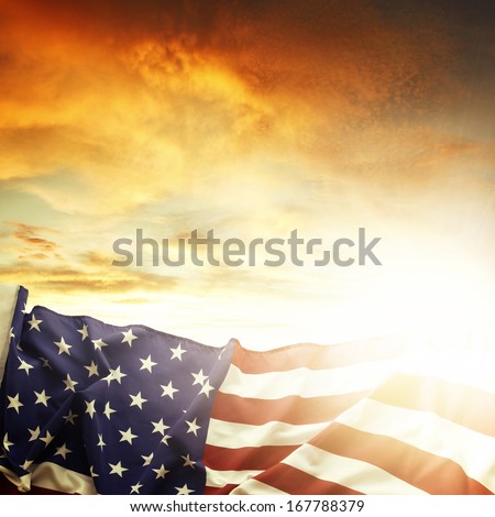 American flag in front of bright sky
