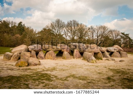 A hunebed in the Holtingerveld near Havelte in the province of Drenthe, ancient prehistoric stones from the ice age and later used as a grave by the Hunen, people also from ancient times Royalty-Free Stock Photo #1677885244