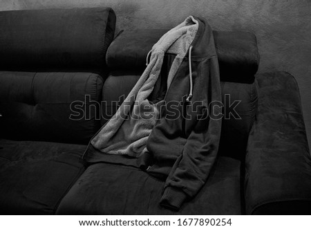 Isolated sweater with fur and with hood on the sofa (Pesaro, Italy, Europe)