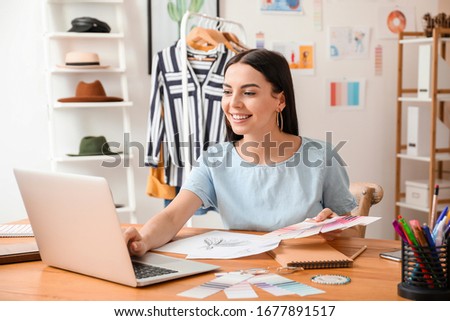 Female clothes stylist working in office