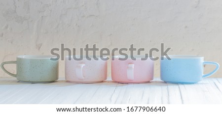 modern ceramic cups on background white wall