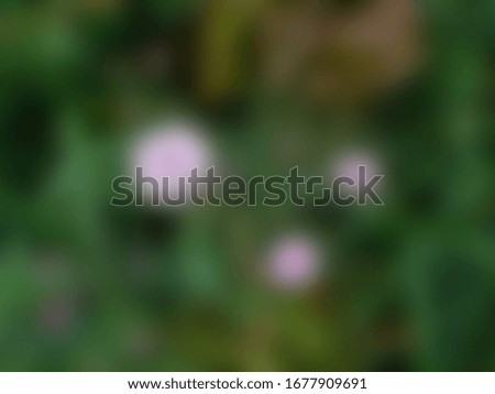 Blurred abstract nature background. Pink flowers in green grass.