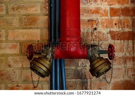 Fire crane on a brick wall background