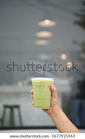 Women’s holdings matcha ice cup.