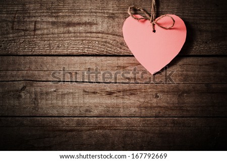 pink  heart made of paper on wooden background