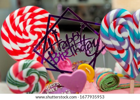 Happy Birthday cake with lollipops and donuts
