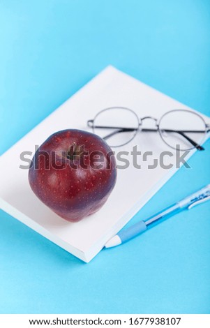A pile of school supplies on a background paper