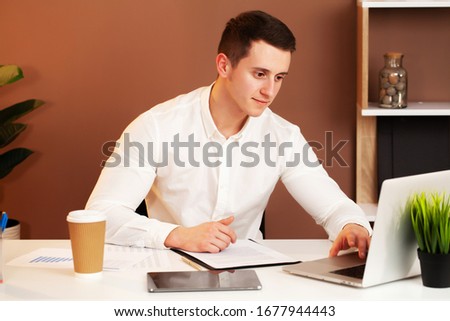 Employee works at the computer in office
