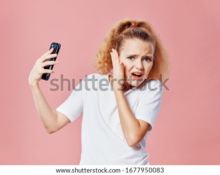 Emotional girl white t-shirt phone in the hands of communication
