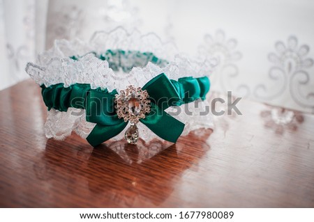 White with green garter on the table