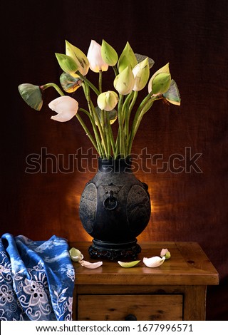 The white lotus flowers in antique vase. Still life. 
