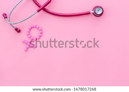 Women's Health issues. Medical concept with Venus sign and stethoscope on pink background top-down copy space