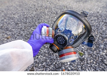 Full-Face Respirator protective gas mask  close up against virus, radiation, bacteria and dust. Professional mask shortage during Covid-19 Coronavirus SARS-CoV-2 pandemic worldwide outbreak. Royalty-Free Stock Photo #1678020910