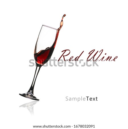 Splashing red wine in a glass isolated on white background