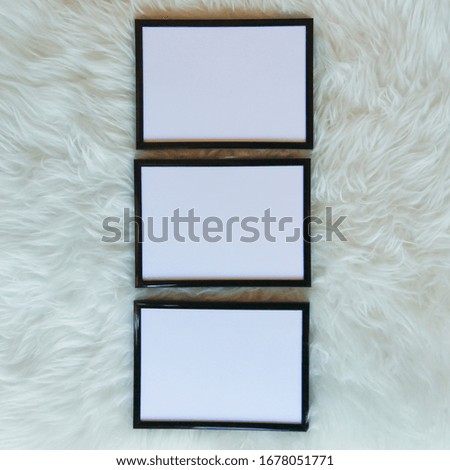Black frames on sheep skin with blank cards for baby decor