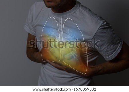 Human lungs, man holding his hand in the area of their lungs.
