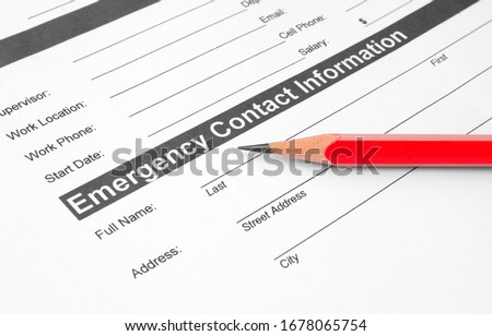 Emergency contact information document with pencil on it Royalty-Free Stock Photo #1678065754