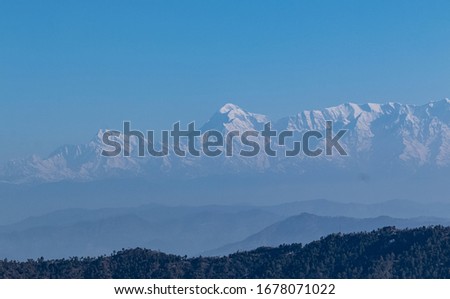 Snow covered mountains scenic view with layers of mountains at uttrakhand