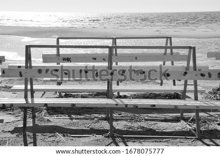 Benches with pictures on the beach in Pärnu, Estonia. Black and white photo.