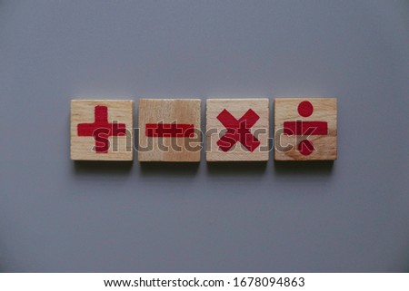 Top view of wooden Addition, subtraction, multiplication and division. They are four basic operations of elementary arithmetic.