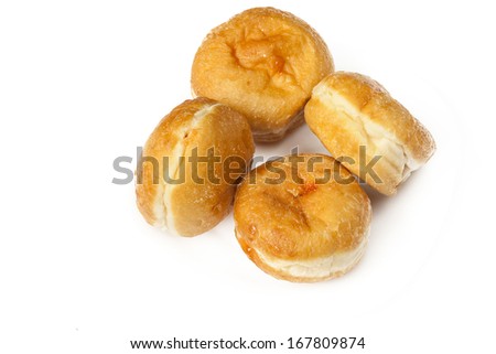 Four sugar donuts on white background