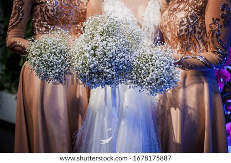 Girls holding white bouquets of flowers in the hands