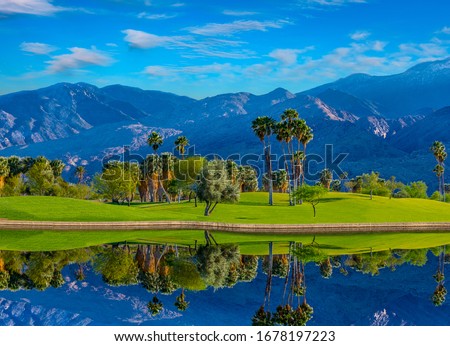Palm Springs, a city in the Sonoran Desert of southern California, is known for its hot springs, stylish hotels, golf courses and spas. Palm trees and green belts create beauty and a dramatic view. Royalty-Free Stock Photo #1678197223