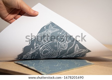 The linocut artwork is transferred on a white paper, dark grey ink is used for this art piece Royalty-Free Stock Photo #1678201690