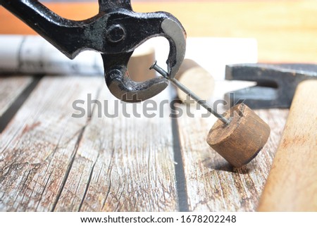 carpenter work tools hammer pincer nail wood Royalty-Free Stock Photo #1678202248
