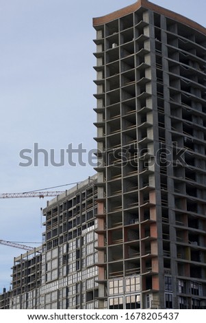 High-rise building under construction. Reinforced concrete frame. Start of installation of double-glazed windows.