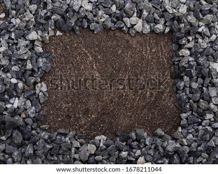 Frame made of gravel. Frame of gravel on concrete floor background. 
