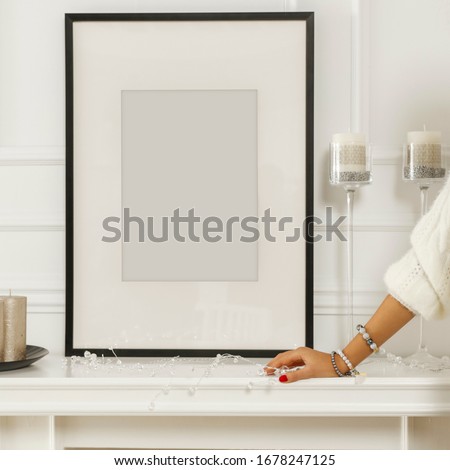 Young woman's hand with white wall background in luxury home interior. Space for advertising product and decoration.