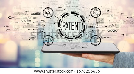 Patent concept with man holding a tablet computer Royalty-Free Stock Photo #1678256656