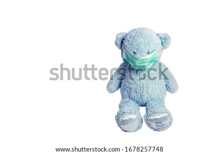Teddy bear in sterile mask on white background. Coronavirus pandemia concept.