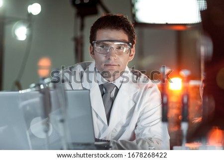 Portrait of a confident male engineer in his working environment. Science and technology concept. Royalty-Free Stock Photo #1678268422
