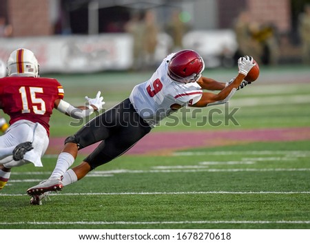 Great action photos of football players making amazing plays during a football game Royalty-Free Stock Photo #1678270618
