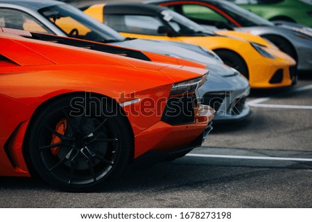 Supercars at the parking lot. Track day at the race track. Fast cars prepared for ride at the raceway. Cars and coffee meet  Royalty-Free Stock Photo #1678273198