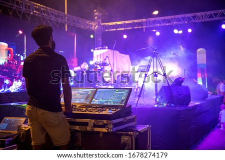 Sound engineer team working to prepare for music concert stage. Hand adjusting audio mixer. DJ for work at a concert in front of the stages Royalty-Free Stock Photo #1678274179
